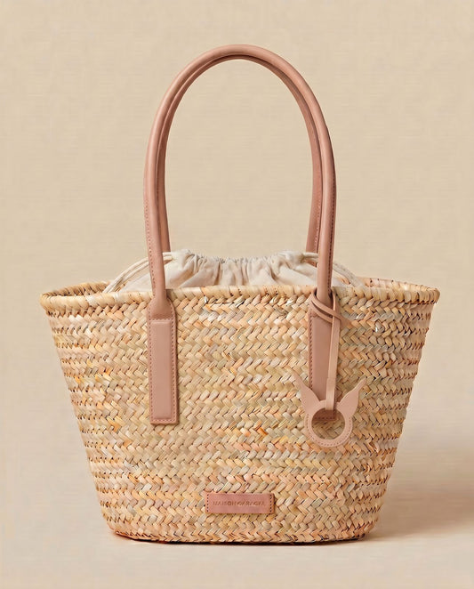 woven straw tote bag with light pink leather handles